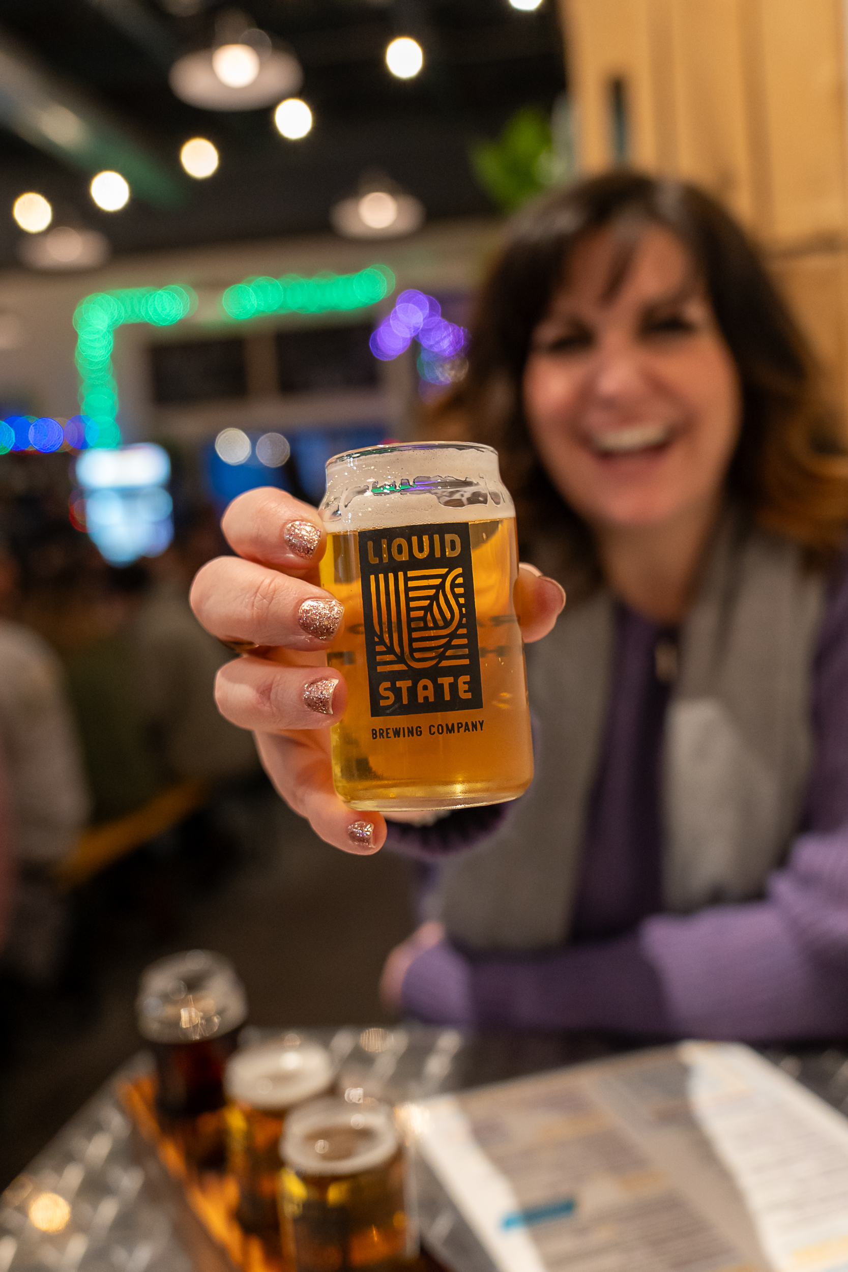 a woman holding a glass of beer